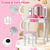 Kids vanity table and stool set in pink with polka dots, featuring a tri-fold mirror and ample storage for toys and.