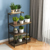 4-tier rustic brown kitchen bakers rack with plants, featuring removable top shelf and sturdy metal frame for versatile.