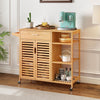 Kitchen island cart on wheels with bamboo frame, featuring shelves, drawer, and towel rack for versatile storage.