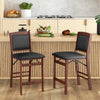 Set of 2 folding kitchen island stools with brown rubber wood legs and black PVC leather seats for compact storage.
