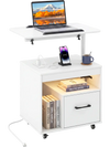 Modern white LED nightstand with flip-over tabletop, power outlets, drawer, and wheels for versatile bedroom use.