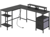 L-shaped black desk with power outlet, adjustable shelves, and reversible monitor stands for versatile office use.