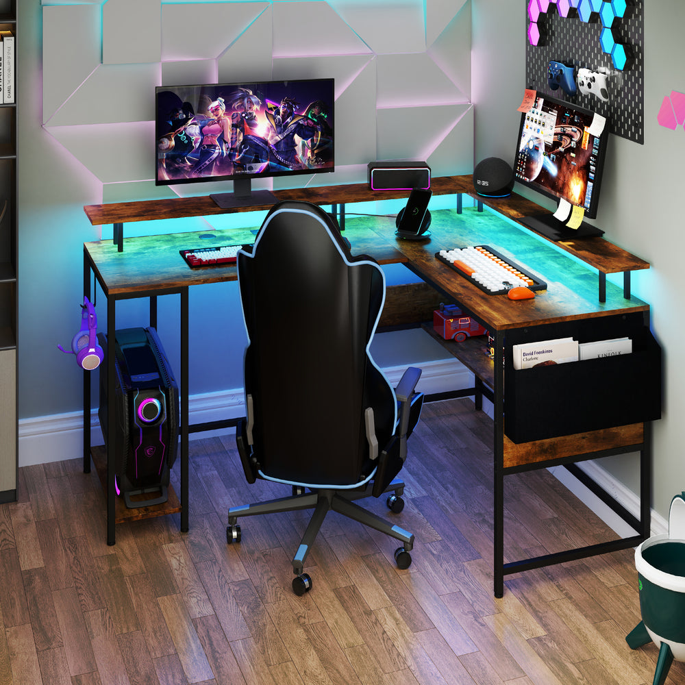 L-shaped gaming desk in rustic brown with LED lights, power outlets, and ergonomic monitor stand for versatile use.
