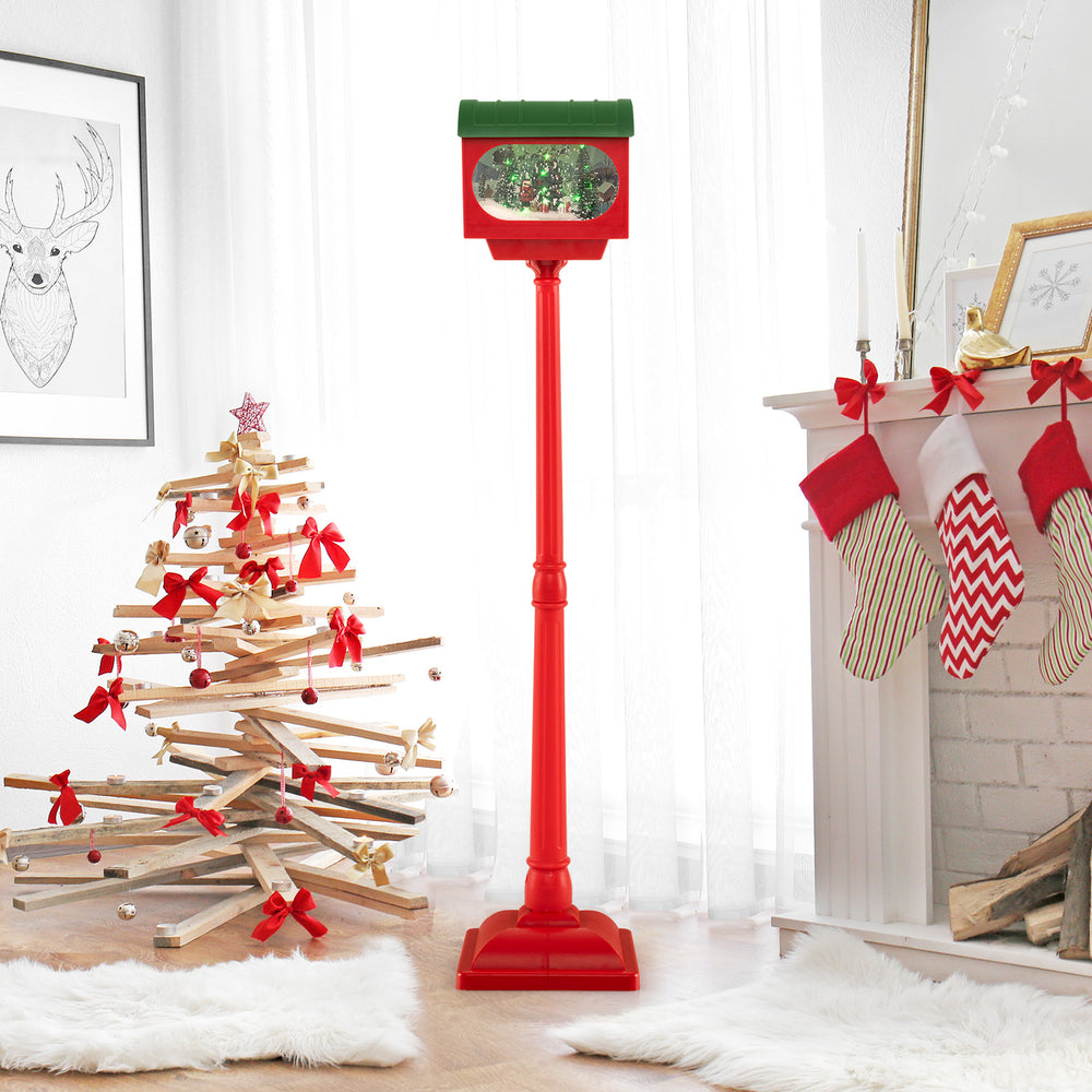 59-inch red Christmas street lamp with sound-activated snow globe lantern, featuring colorful lights and festive scenes.