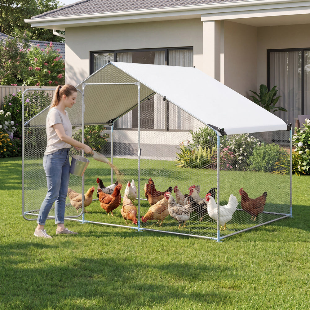 Large metal chicken coop with waterproof cover, featuring a galvanized steel frame and spacious interior for poultry.