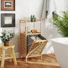 Bamboo tilt-out laundry hamper with removable basket, two shelves, and raised legs for bathroom or laundry room use.