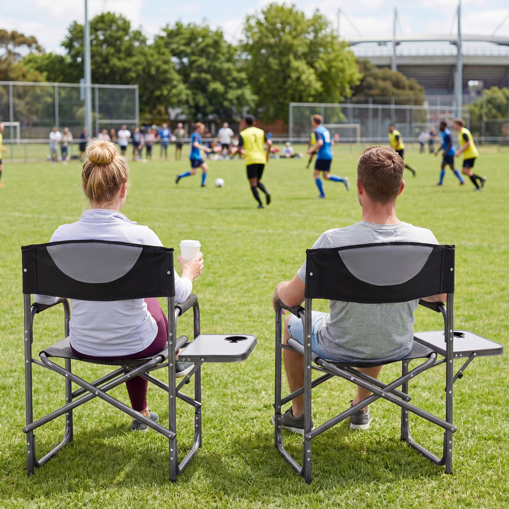 Lightweight folding camping chair in black with side table, ideal for sports events and outdoor activities.