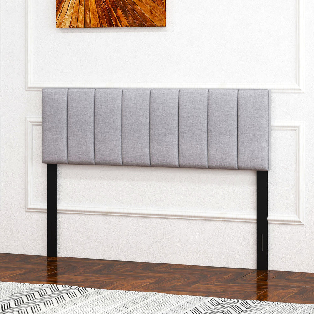 Gray linen upholstered headboard with vertical channel tufting and solid wood legs, adjustable for full or queen size.