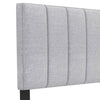 Gray linen upholstered headboard with vertical channel tufting, solid wood legs, and adjustable width for full or queen.