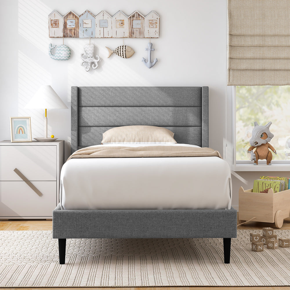 Twin size bed frame with a wingback headboard in soft linen, showcasing elegant quilting and solid wood legs for.