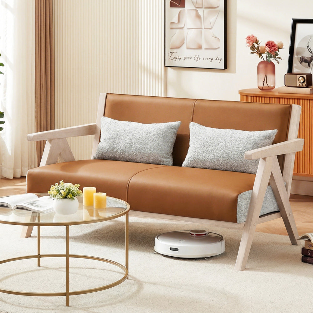 Brown loveseat sofa with rubber wood frame, padded seat, and throw pillows, perfect for small spaces and stylish.