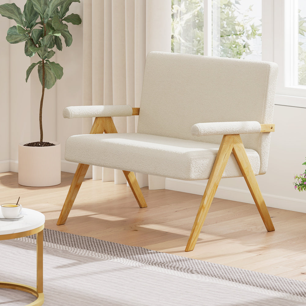 Beige loveseat sofa with armrests and wooden legs, featuring soft sherpa fabric and a slanted backrest for comfort.