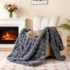 Luxury fuzzy plush rabbit fur bubble blanket in gray draped over an armchair, perfect for cozy warmth and comfort.