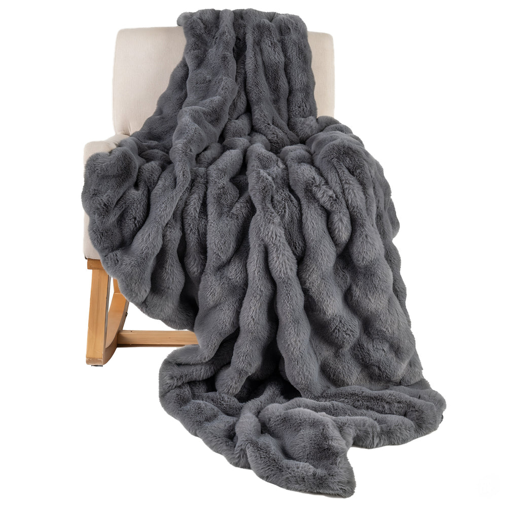 Luxury gray fuzzy plush rabbit fur bubble blanket draped over an armchair, offering softness and warmth for cozy.