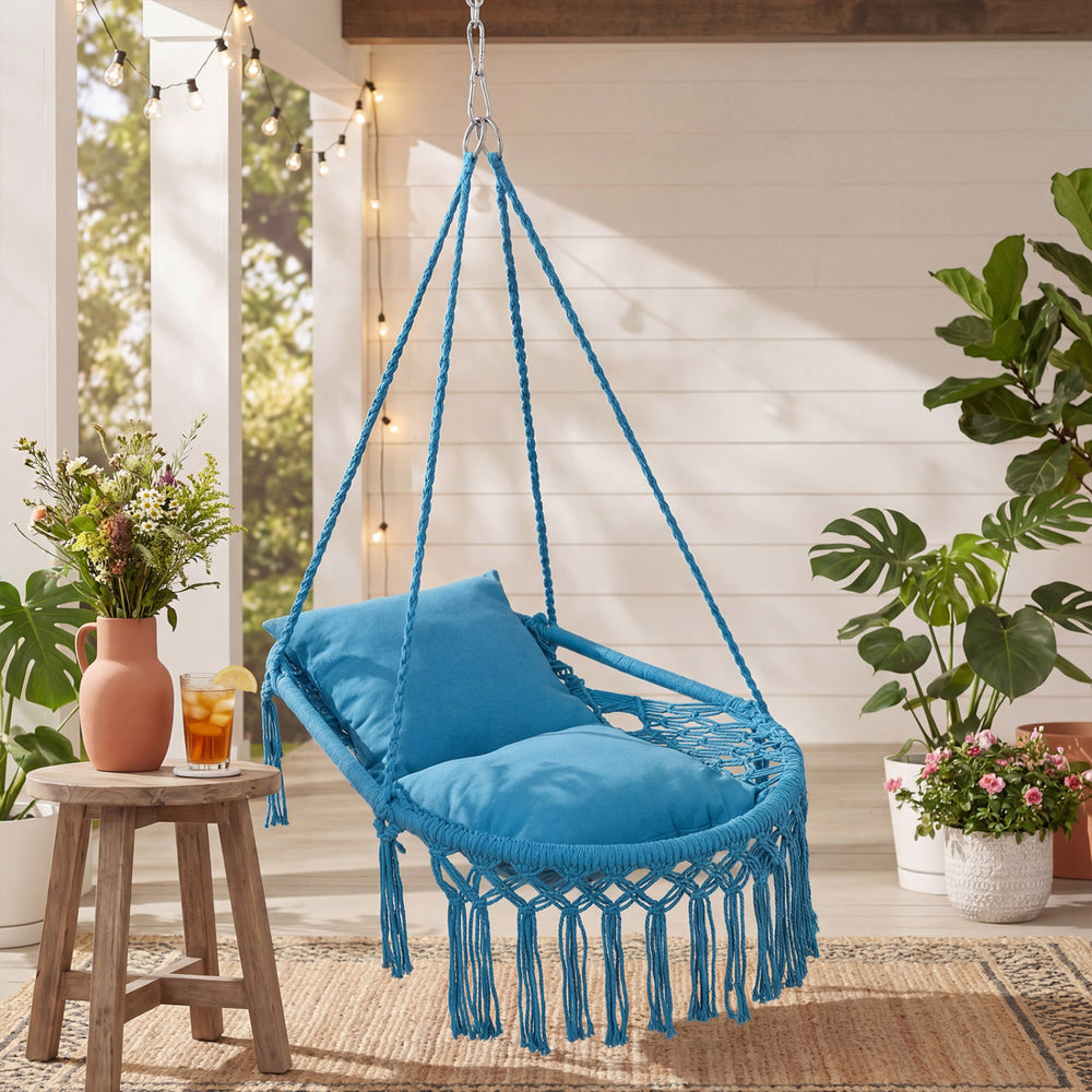 Macrame swing chair hammock in blue with removable cushions, featuring decorative fringes for indoor or outdoor use.