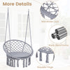 Macrame swing chair with grey round seat cushion, sturdy metal frame, and decorative fringes for indoor or outdoor use.