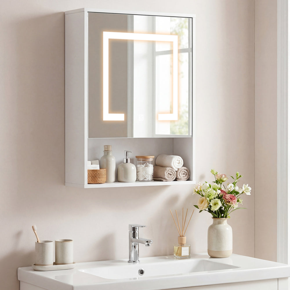 White medicine cabinet with mirror and three color LED lights, wall-mounted above a sink with decorative items.