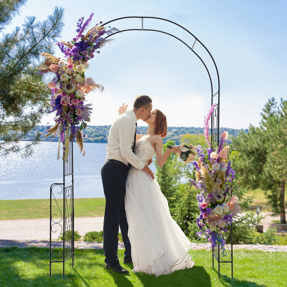 Metal garden arch backdrop stand with elegant design, perfect for weddings and climbing plants, set against a scenic.
