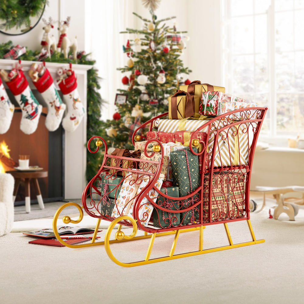 Elegant red metal Christmas Santa sleigh basket with gifts, featuring a sturdy golden base for holiday decoration and.