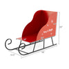 Red metal Christmas Santa sleigh basket with festive motifs, perfect for storing gifts and decorations, measures 29".