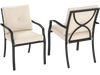 Stackable metal outdoor dining chairs with beige cushions, featuring ergonomic design and curved armrests for patio.