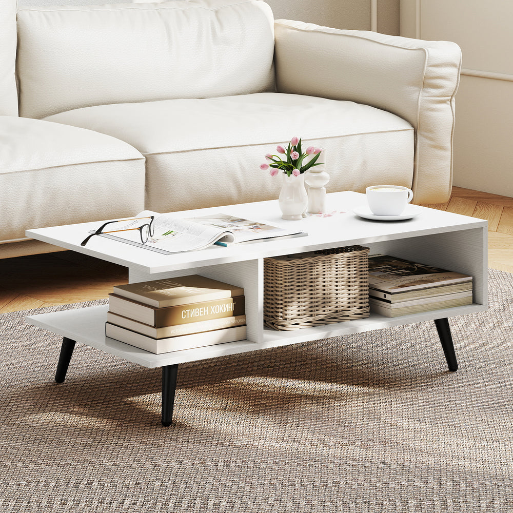 Mid Century Modern rectangle coffee table with white finish, featuring 2 open compartments and tapered metal legs.