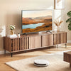 Mid-century modern entertainment center in walnut with slatted doors and four storage cabinets, perfect for living.