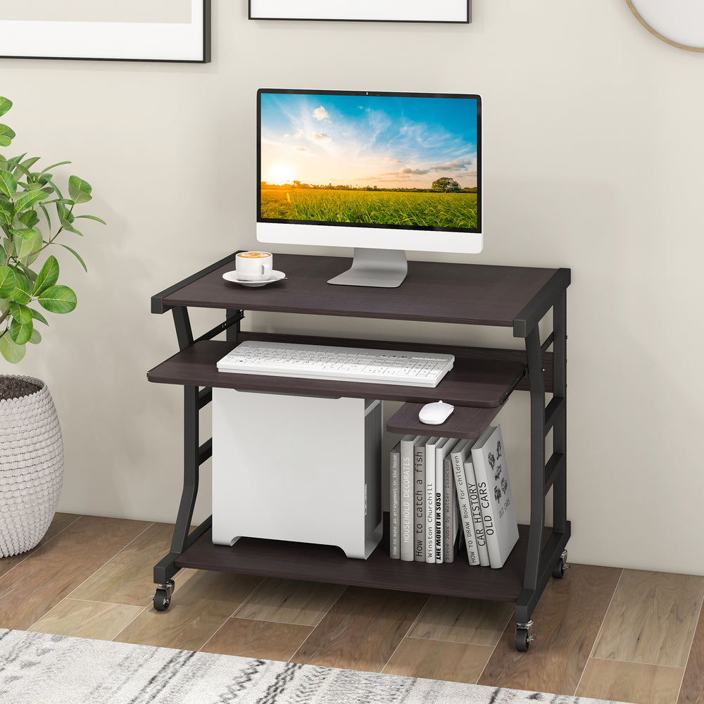 Mobile computer desk in dark brown with keyboard tray, mouse tray, and bottom shelf for storage, ideal for small spaces.