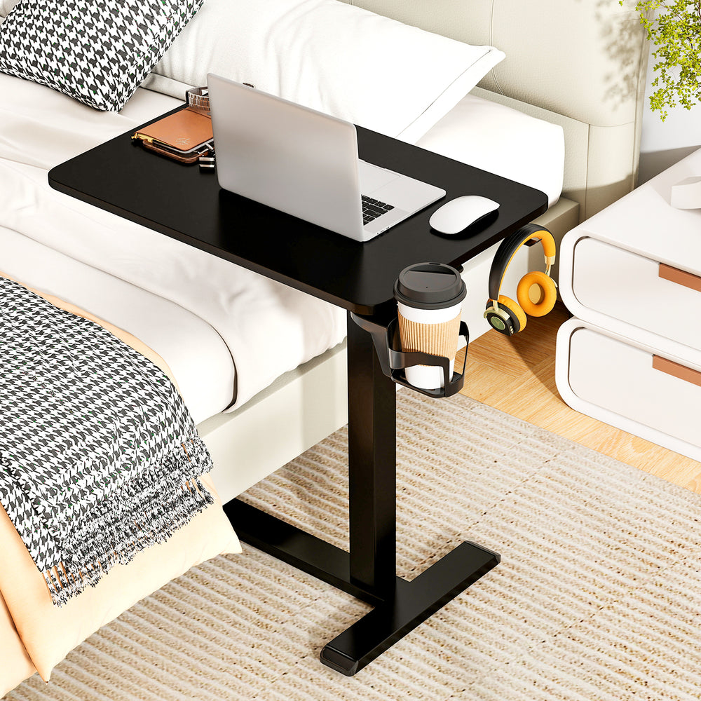 C-shaped mobile standing desk in black with adjustable height, cup holder, and convenient headphone hook for bedside.