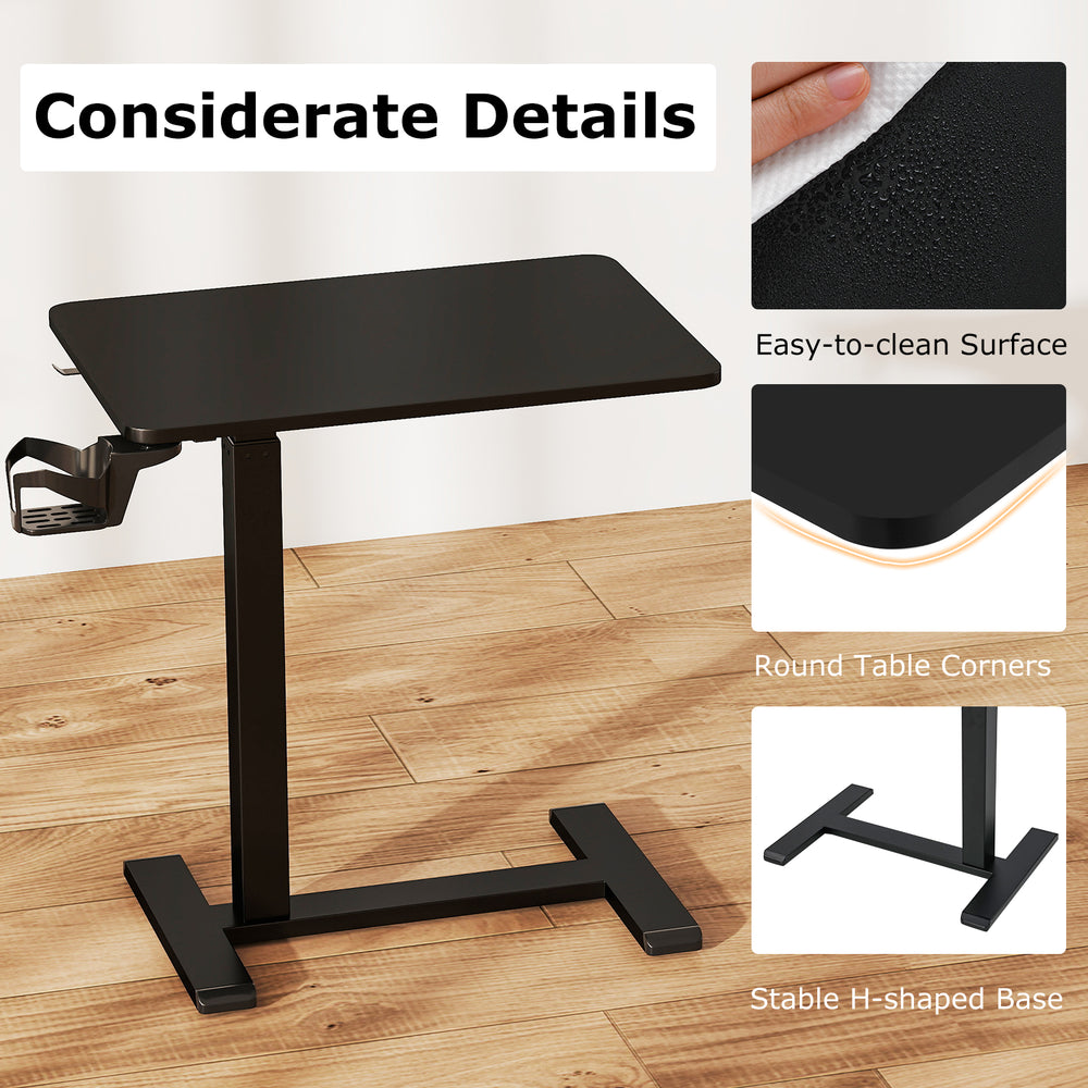 Height adjustable mobile standing desk in black with a spacious tabletop and cup holder, perfect for bedside use.