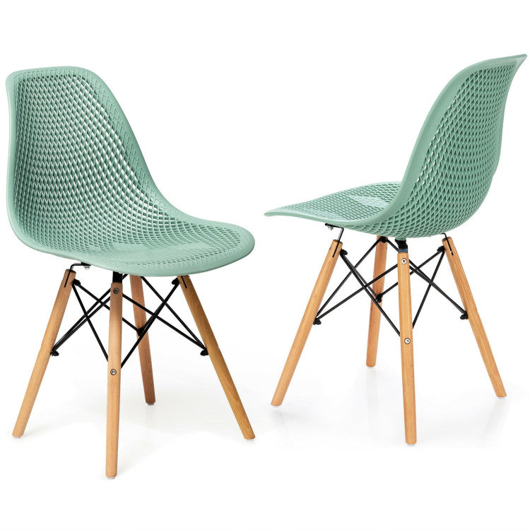 Hollow plastic chair in mint green with beech wood legs, designed for modern dining and small spaces.