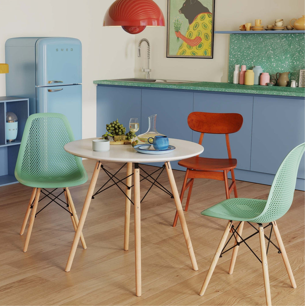Round dining table with two hollow plastic chairs in mint green, perfect for small spaces and versatile use.