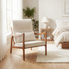 Modern accent chair with solid rubber wood frame and faux leather upholstery, perfect for cozy living spaces.