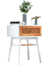 Modern bedside table with solid wood legs, rattan front panel, and a large drawer for convenient storage in white.