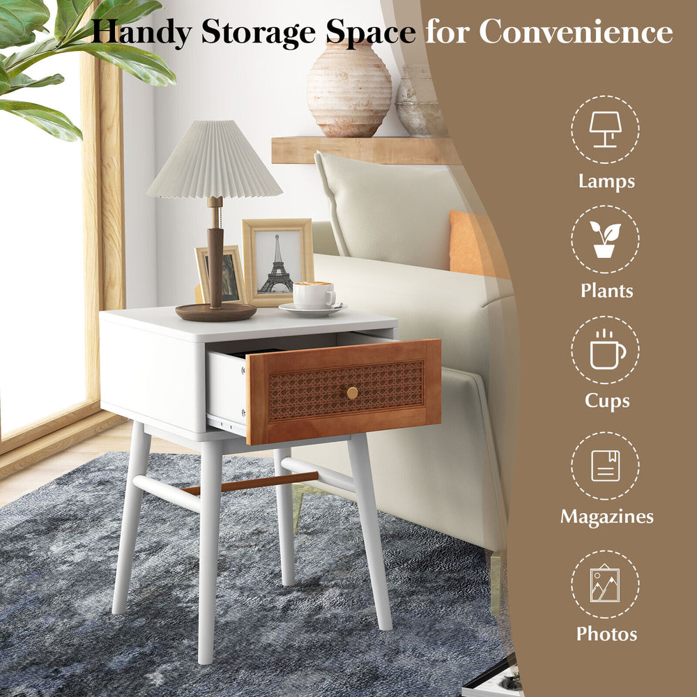 Modern bedside table with solid wood legs, rattan drawer front, and wide tabletop for lamps and plants in white finish.