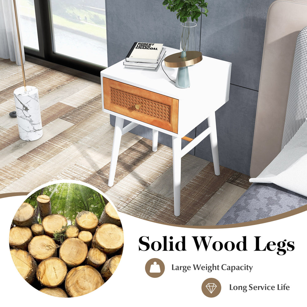 Modern bedside table with solid wood legs, rattan front panel, and large drawer for convenient storage in white finish.