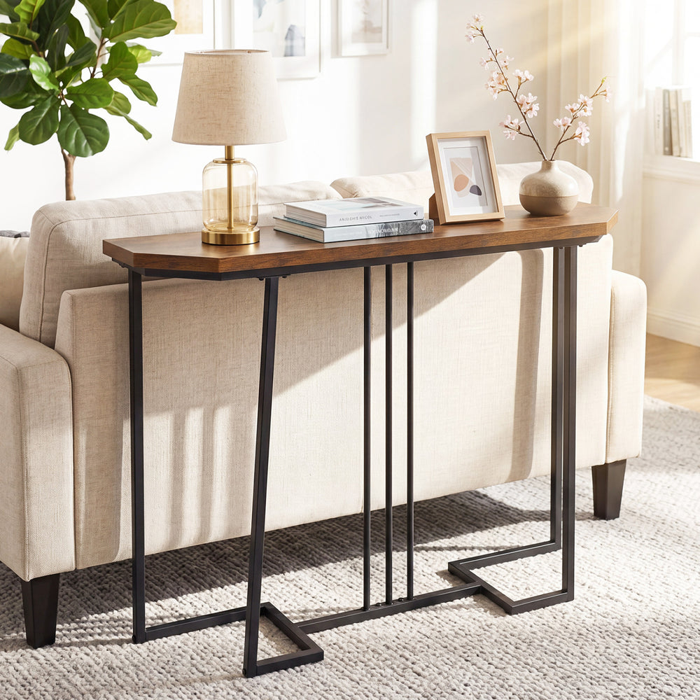 Narrow entryway console table in rustic brown with metal legs, perfect for organizing items behind sofas.