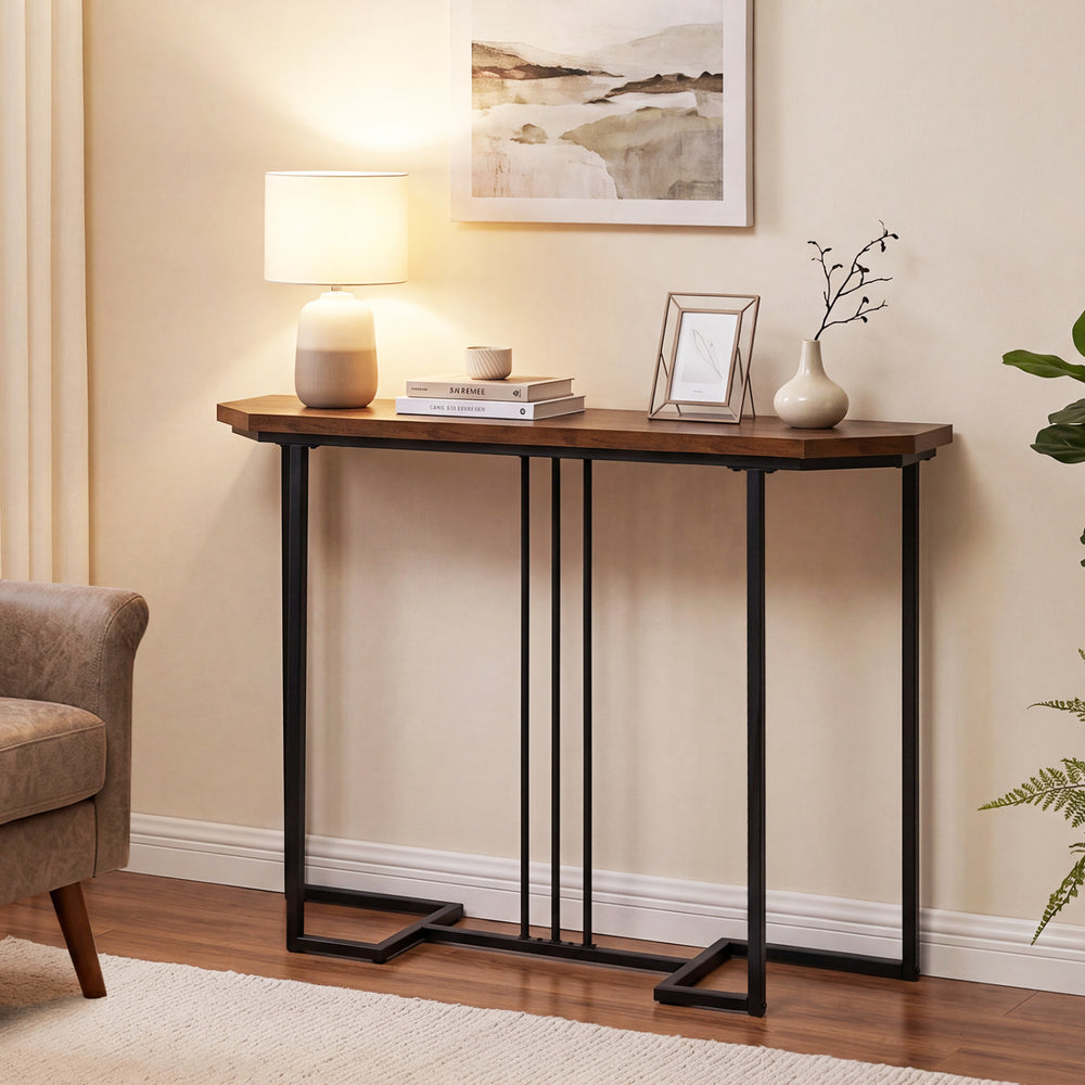 Narrow rustic brown console table with metal legs, perfect for entryways or behind sofas, featuring a spacious tabletop.