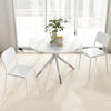 Modern white dining table with two chairs, featuring a sturdy metal frame and an inclined backrest for comfort.