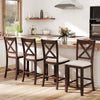 Counter height stools in walnut with slatted back, cushion, and footrest, perfect for dining rooms and cafes.