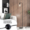Modern floor lamp with a black finish and clear glass lampshade, featuring a convenient foot switch for easy control.