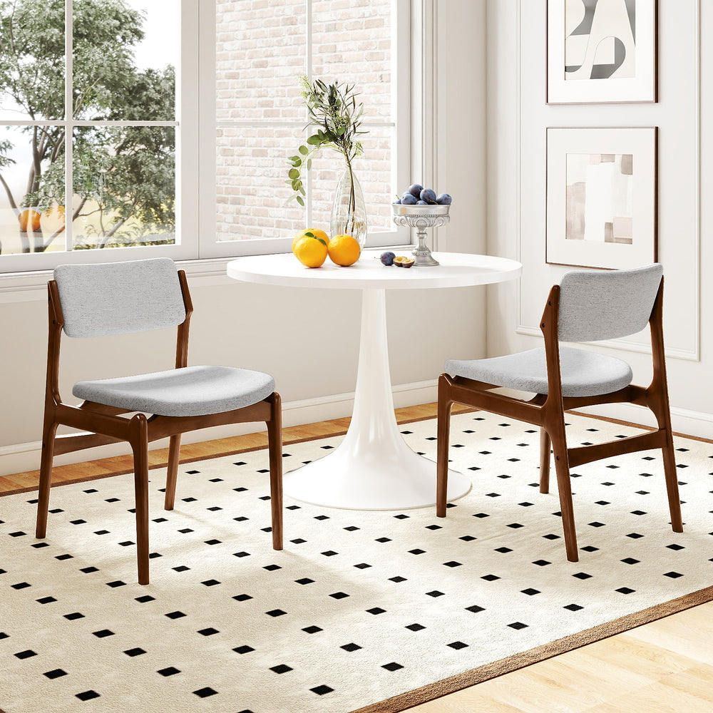 Modern padded dining chairs with rubber wood legs, featuring gray linen fabric and a stylish farmhouse design for.