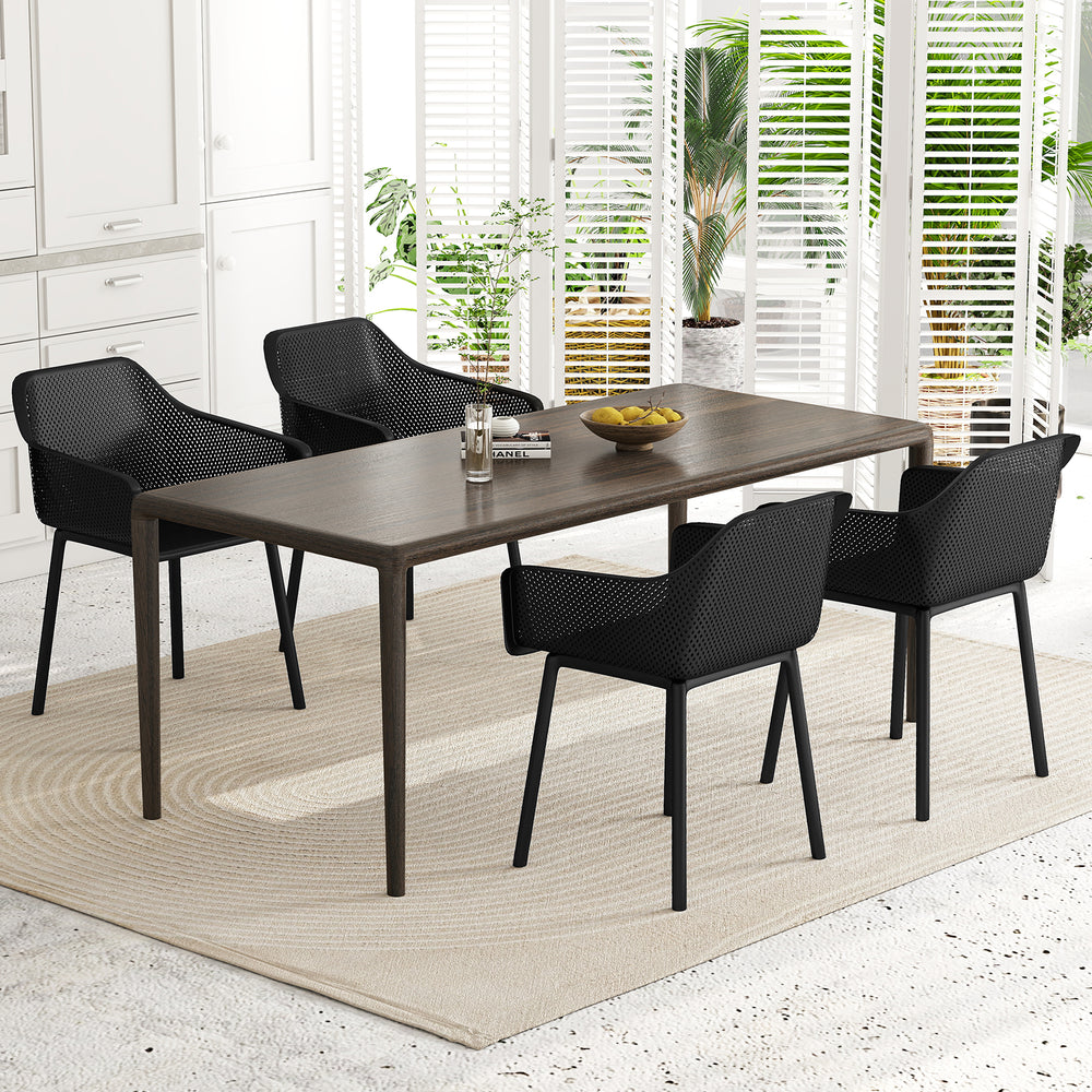 Modern dining table with four ergonomic black plastic chairs featuring breathable mesh backrests for ultimate comfort.