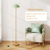 Modern standing lamp with adjustable head and foot switch, featuring a green lampshade and gold base, ideal for any.