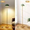 Modern standing lamp with adjustable head, gold base, and foot switch, ideal for living room or bedroom lighting.