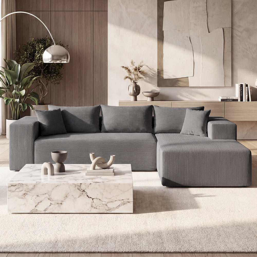 L-shaped modular sectional sofa in gray corduroy with deep seats, perfect for comfortable seating for four.
