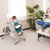 Multifunctional pink baby high chair with adjustable height, rolling wheels, and removable tray for mealtime.