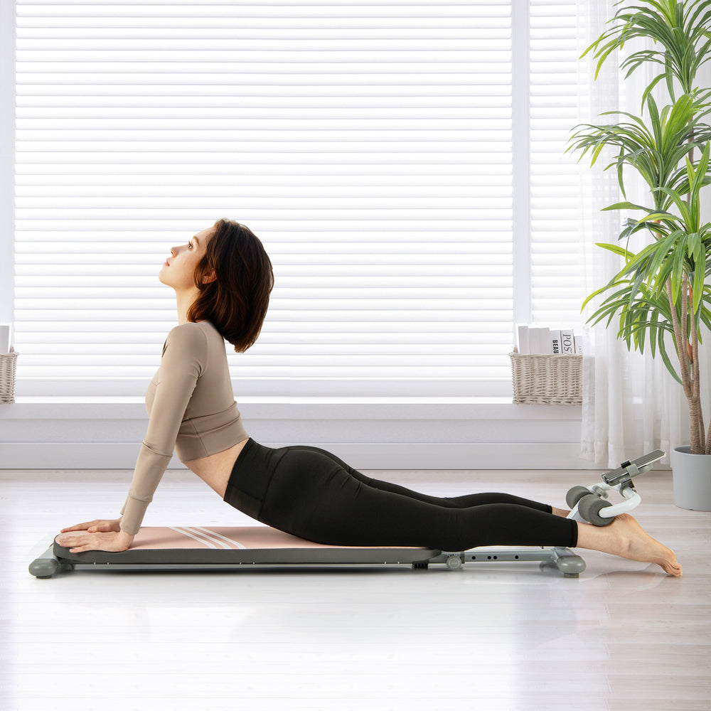 Pink multifunctional sit-up bench shown in use, highlighting adjustable angles and high-density cushion for effective.