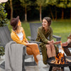 Adirondack rocking chair in gray with curved backrest, perfect for outdoor relaxation on the balcony.