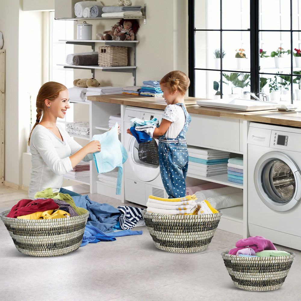 Stackable set of 3 natural canes grass baskets with hollowed handles for easy storage and organization.
